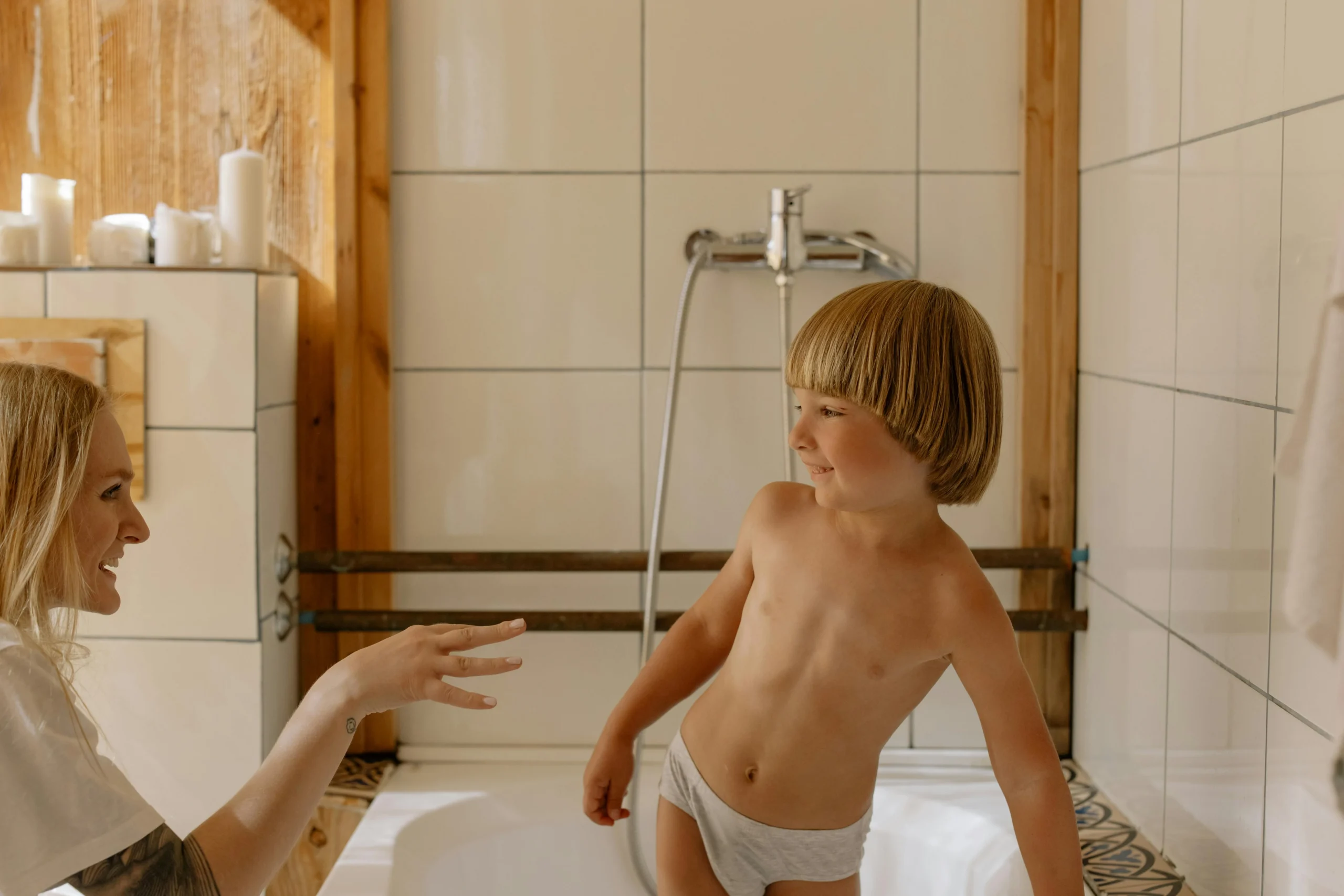 Tout-petit assis sur son pot dans la salle de bain en souriant